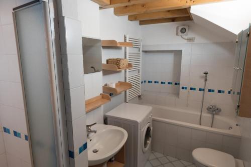 a bathroom with a sink and a toilet and a tub at Casa Piazza Del Porto in Lovere