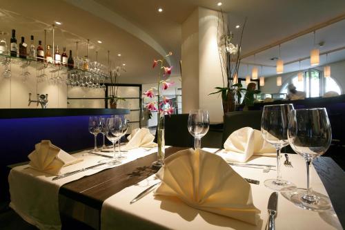 a table in a restaurant with wine glasses on it at Sorell Hotel Speer in Rapperswil-Jona