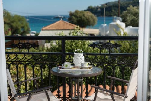 a table on a balcony with two cups of coffee at Bratis Apartments in Keri