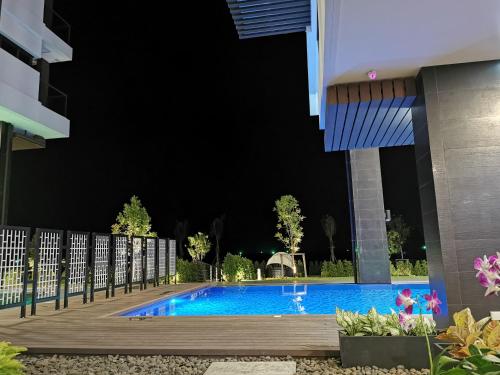 a swimming pool in the middle of a building at night at Escape Condominum E125 in Mae Pim