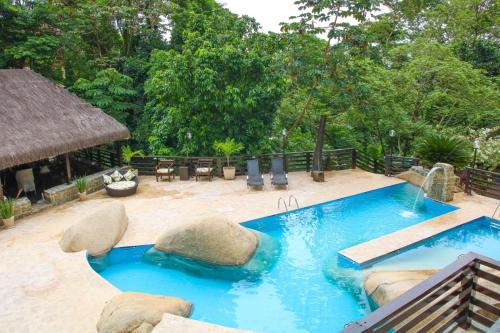 a swimming pool in a backyard with a resort at Casa Pedra Bonita in Rio de Janeiro