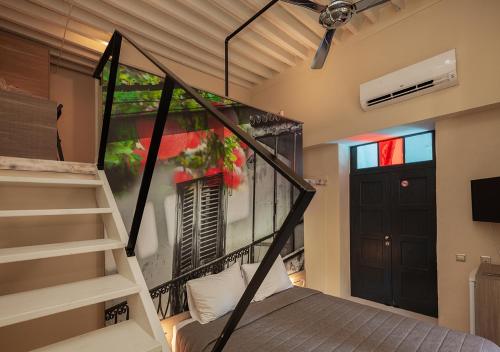 a room with a bed and a staircase and a door at Casa Mespilea in Paphos City