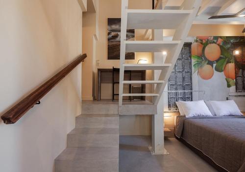 a staircase leading to a bedroom with a bed and a stair case at Casa Mespilea in Paphos City