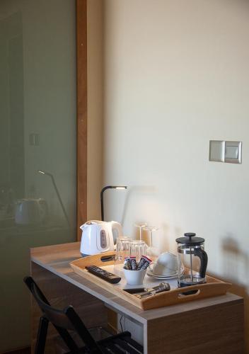 a table with a cutting board and a chair at Casa Mespilea in Paphos City