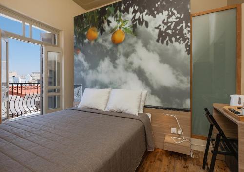 a bedroom with a large painting of oranges on the wall at Casa Mespilea in Paphos City