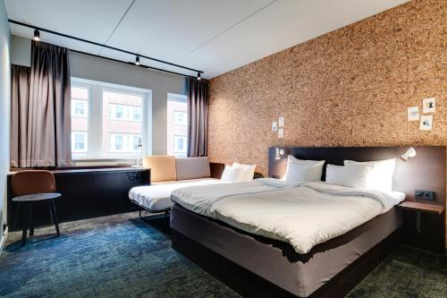a hotel room with two beds and a window at Comfort Hotel Kista in Stockholm