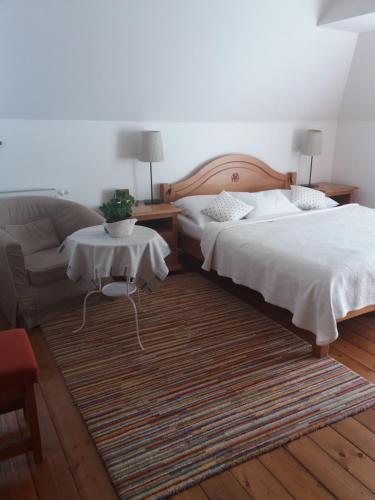 a bedroom with two beds and a couch and a table at Penzión Paula in Tatranská Lomnica