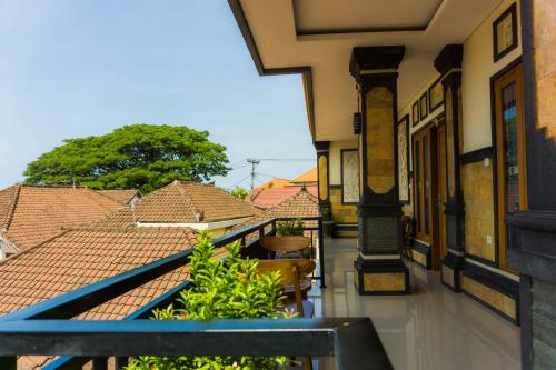 a balcony with a view of the roofs of houses at Cakra House in Denpasar