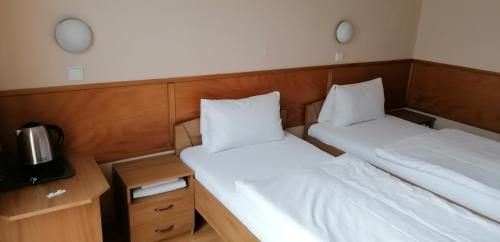 Postel nebo postele na pokoji v ubytování Pension Magnolia