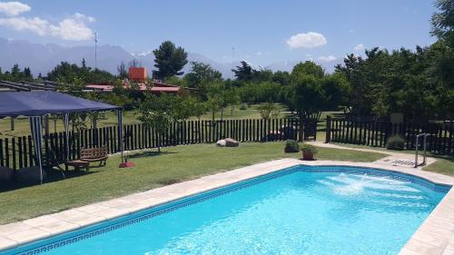 een zwembad in een tuin met een hek bij La Posada Del Jamón in Vista Flores