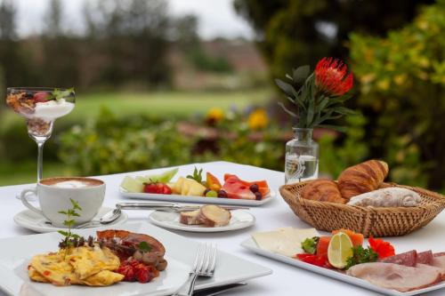a table with plates of food and a glass of wine at Oliver`s in White River