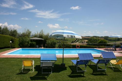 un gruppo di sedie e tavoli accanto alla piscina di CERRETINI a Montepulciano