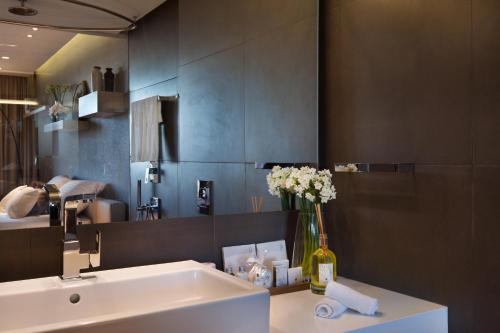 a bathroom with a white sink and a mirror at Cramim by Isrotel Exclusive in Qiryat ‘Anavim