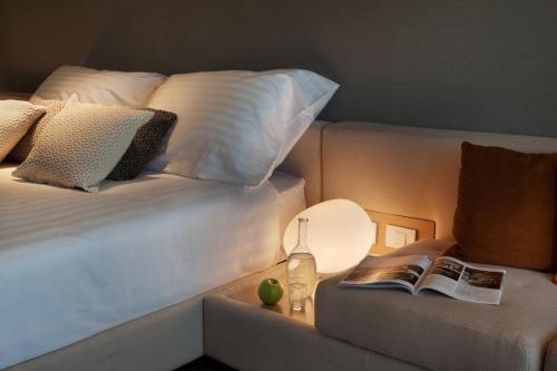 a bedroom with a bed and a table with a lamp at Cramim by Isrotel Exclusive in Qiryat ‘Anavim