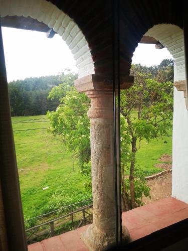 a view of a field from a window at Inka Tambo Hacienda in Cusco
