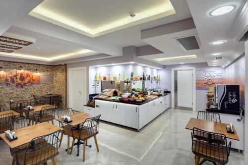 a kitchen with a table, chairs, and a table cloth at OBAHAN HOTEL in Istanbul