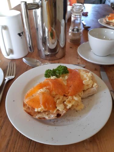 a white plate with a piece of food on a table at Woodlands Cottage Farm in Wickham