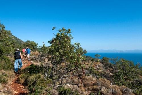 a group of people walking on a mountain trail at Studios Kyparissi & Spa in Tiros
