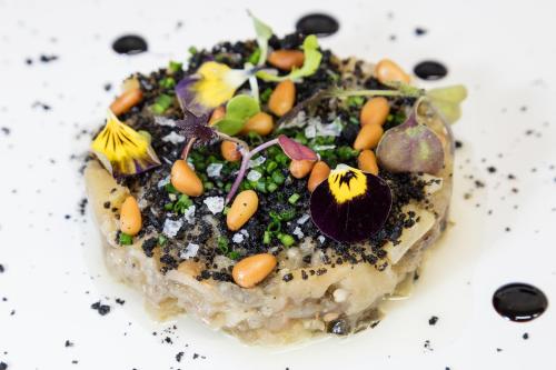 a dessert with vegetables on top on a white plate at Acta Voraport in Barcelona