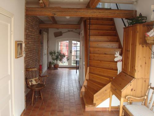 a hallway with a wooden staircase in a house at Lyckås Gårds Gästboende in Höganäs