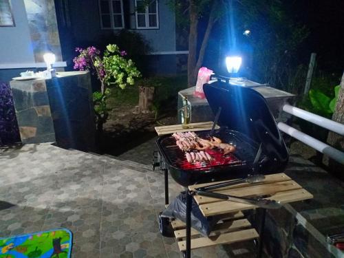 a bbq grill on a patio at night at บ้านนกเคียงจัน ปากช่อง Nok Kiang Chan Home Pak Chong in Ban Nong Ka Cha