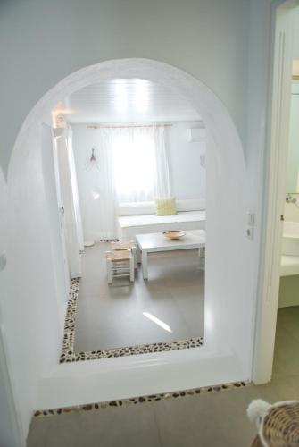 a white room with a table and a window at Agnandi Cielo in Tourlos