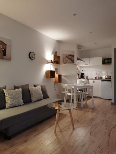 un salon avec un canapé et une table dans l'établissement La maisonnette au centre ville, à Lens