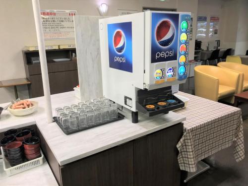 a coffee machine sitting on top of a counter at Hotel 1-2-3 Kokura in Kitakyushu
