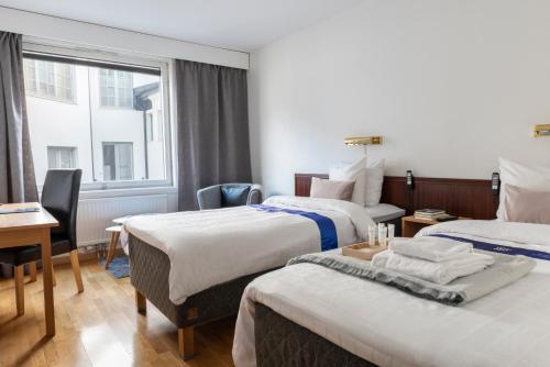 Postel nebo postele na pokoji v ubytování First Hotel Stadt