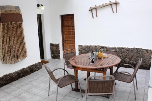 a wooden table and chairs in a room at Apartamentos Finca Wapa in Frontera