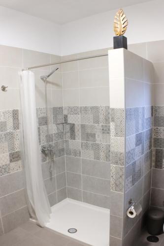a shower with a glass door in a bathroom at Apartamentos Finca Wapa in Frontera