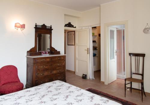 a bedroom with a bed and a dresser and a chair at Marbel Gandolfo in Castel Gandolfo