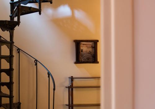 a staircase in a house with a clock on the wall at Marbel Gandolfo in Castel Gandolfo