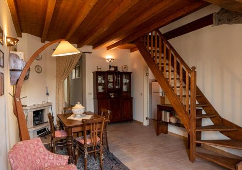 a living room with a wooden staircase and a table at Marbel Gandolfo in Castel Gandolfo