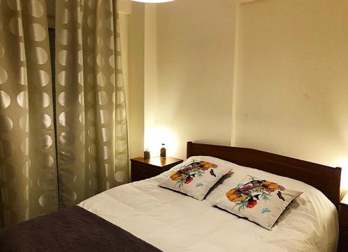 a bedroom with a bed with two pillows on it at Apartament in Thessaloniki in Paliókastron