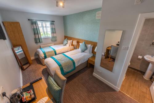 a hotel room with two beds and a sink at Queen Street Tap in Deal
