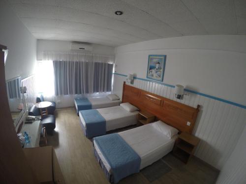 Postel nebo postele na pokoji v ubytování Asty Hotel