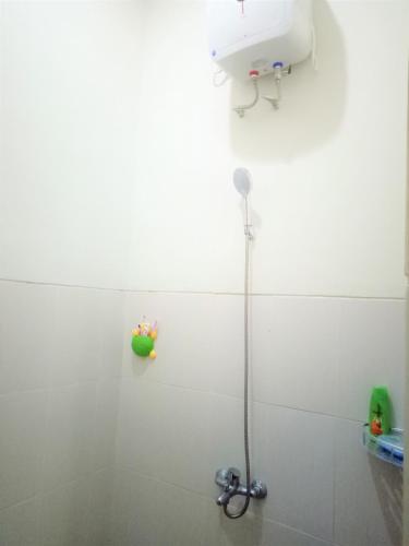 a shower in a white bathroom with a sink at Alysahouse - 2 Bedrooms, Dekat JTP3 in Batu