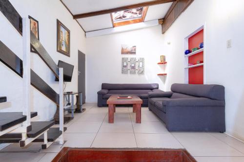 a living room with two couches and a table at Linden Guest House in Johannesburg