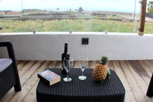 a table with a pineapple and wine glasses on it at Apartamentos Finca Wapa in Frontera
