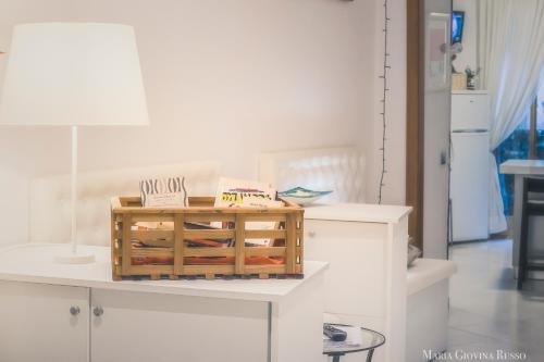 a white room with a table with a lamp at Casa in Centro Foggia in Foggia