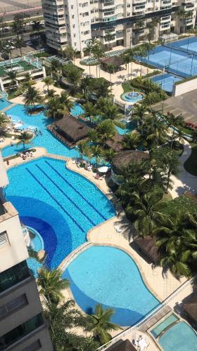 an aerial view of a resort with pools and palm trees at Apartamento Bora Bora in Rio de Janeiro