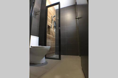 a bathroom with a toilet and a glass shower at Mary's Residence Ipoh in Ipoh