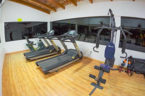 a gym with three tread machines in a room at Sofisticatto Park Hotel in Formosa