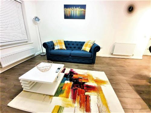 a living room with a couch and a table at Manchester Holiday Apartment in Manchester