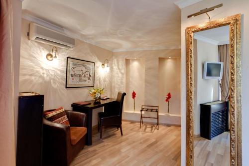 a living room with a mirror and a desk at MOXA Bucharest Boutique Hotel in Bucharest