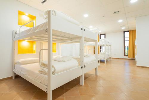 a room with four bunk beds in it at Benarrabá Hostel in Benarrabá