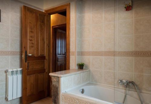 a bathroom with a bath tub in a room at Casa Rural La Panera in Cillamayor