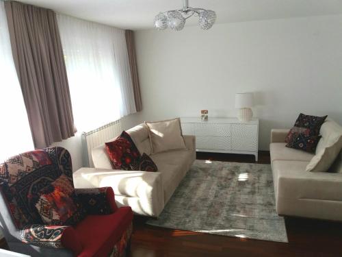 a living room with a couch and two chairs at Apartment Esha in Sarajevo