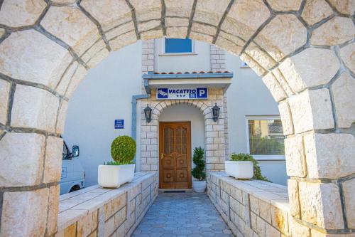 an archway in front of a building with a door at Vacattio apartment 2 in Crikvenica